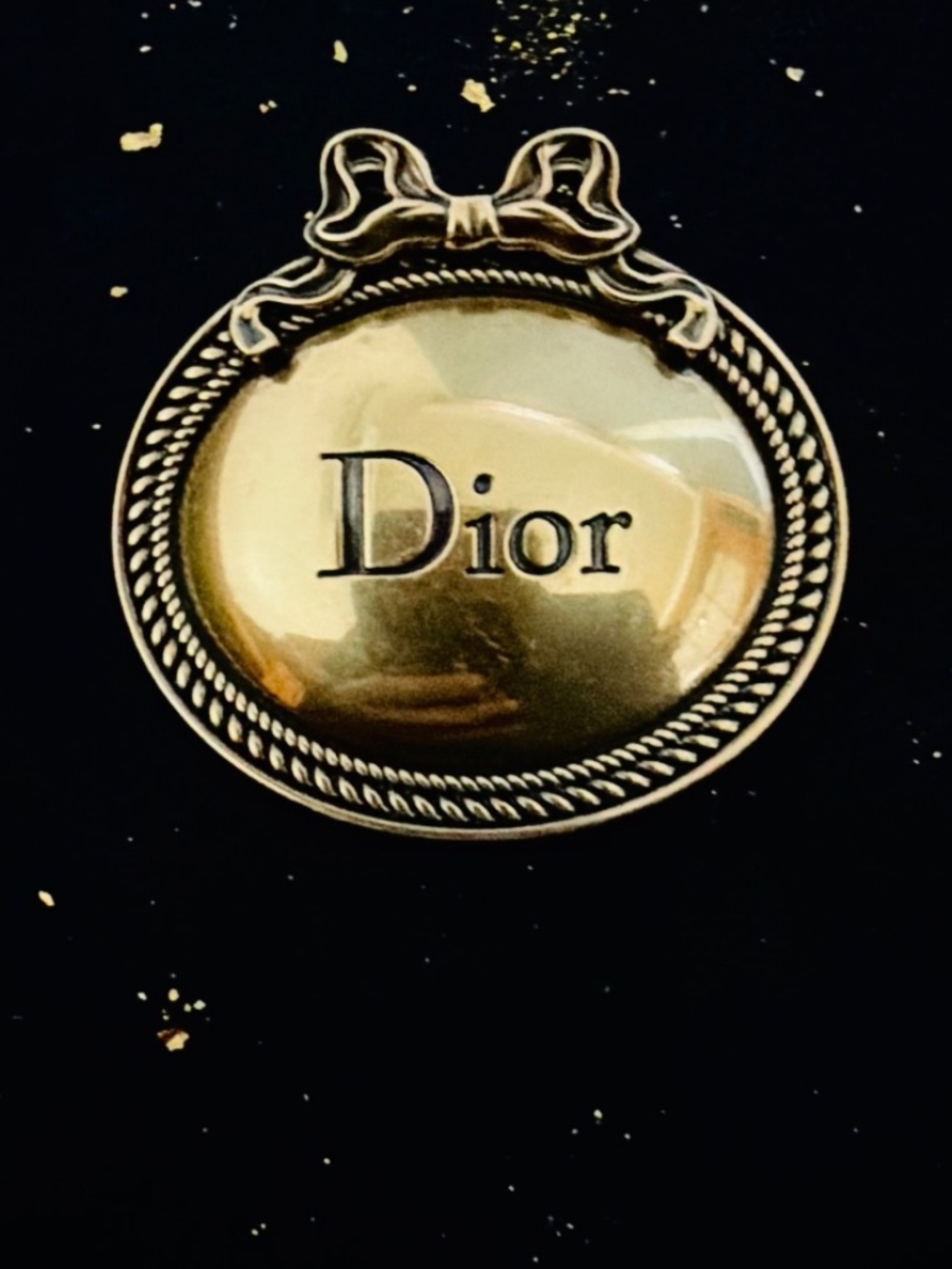 Dior. Brushed Gold Tone Antiqued Medallion Bow Brooch